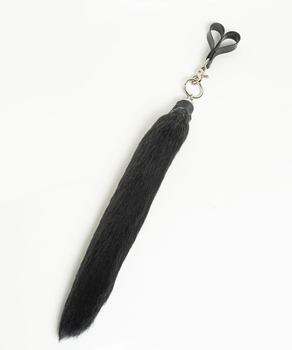 Faux Foxtail Finger Flogger in Black pictured against a white background. 