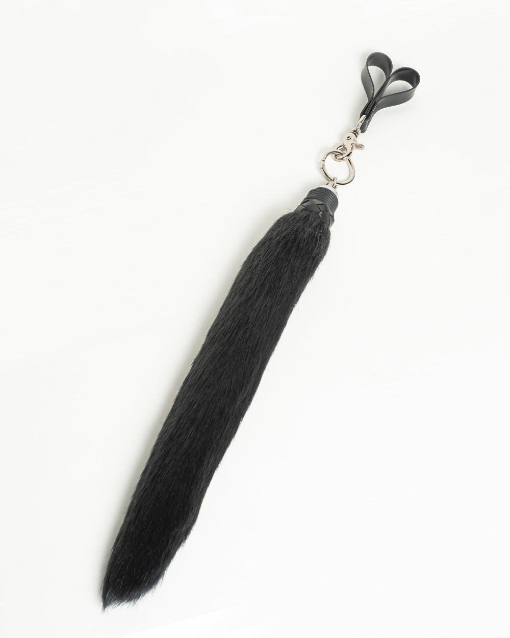 Faux Foxtail Finger Flogger in Black pictured against a white background. 