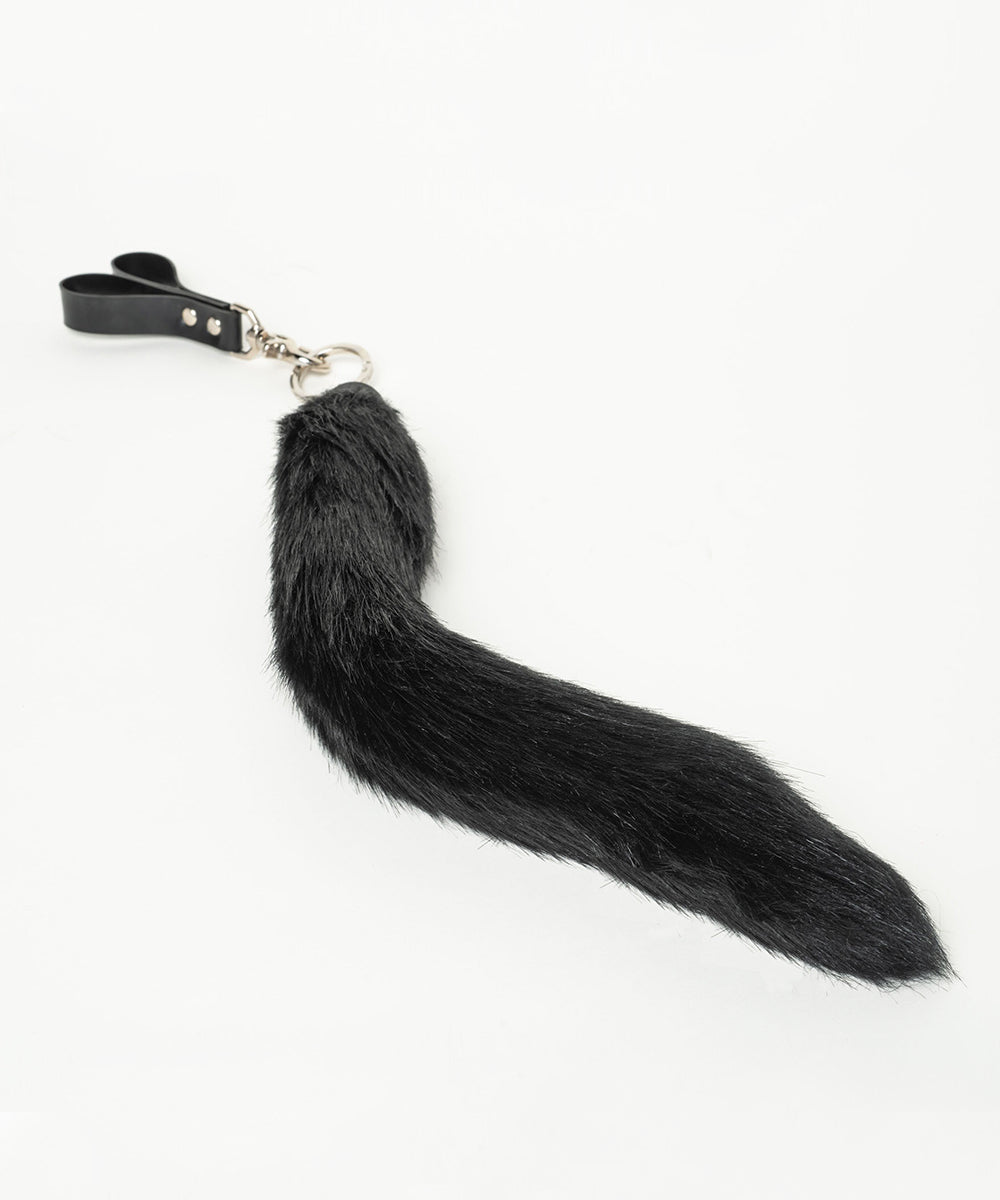 Black faux fur tail flogger on a white background