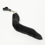 Black faux fur tail flogger on a white background