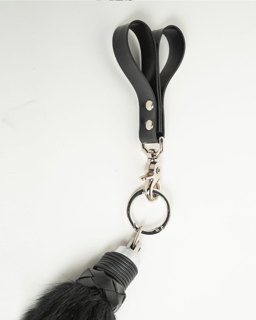 Black rubber finger flogger handle close up on a white background