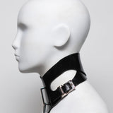 Black leather choker with metal buckle on a mannequin head against a white background
