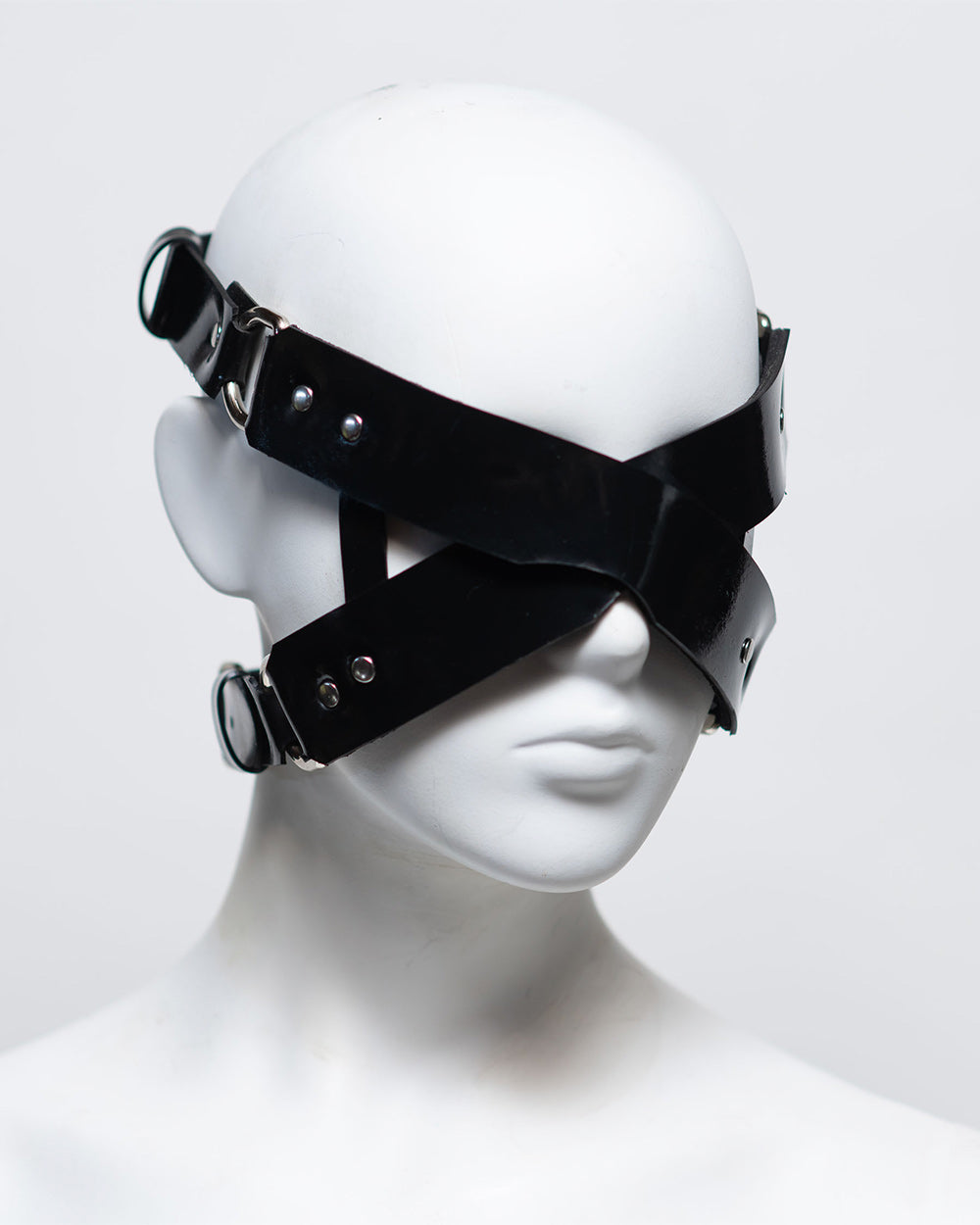 The front of the zafira cross padded blindfold is shown on a white mannequin in front of a white background. 