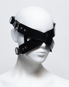 The front of the zafira cross padded blindfold is shown on a white mannequin in front of a white background. 