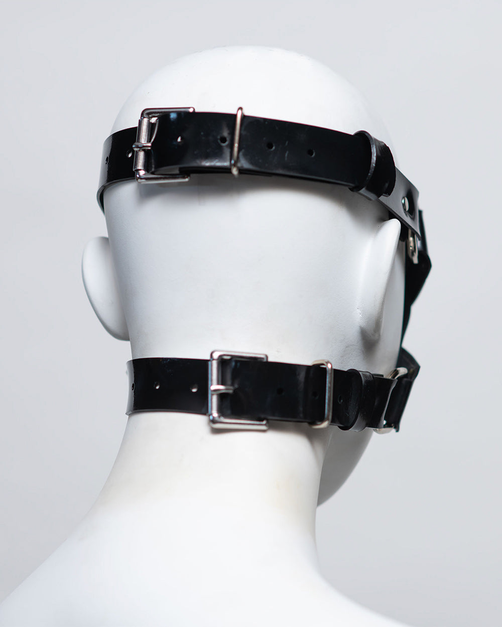 The back of the zafira cross padded blindfold is shown on a white mannequin in front of a white background. 