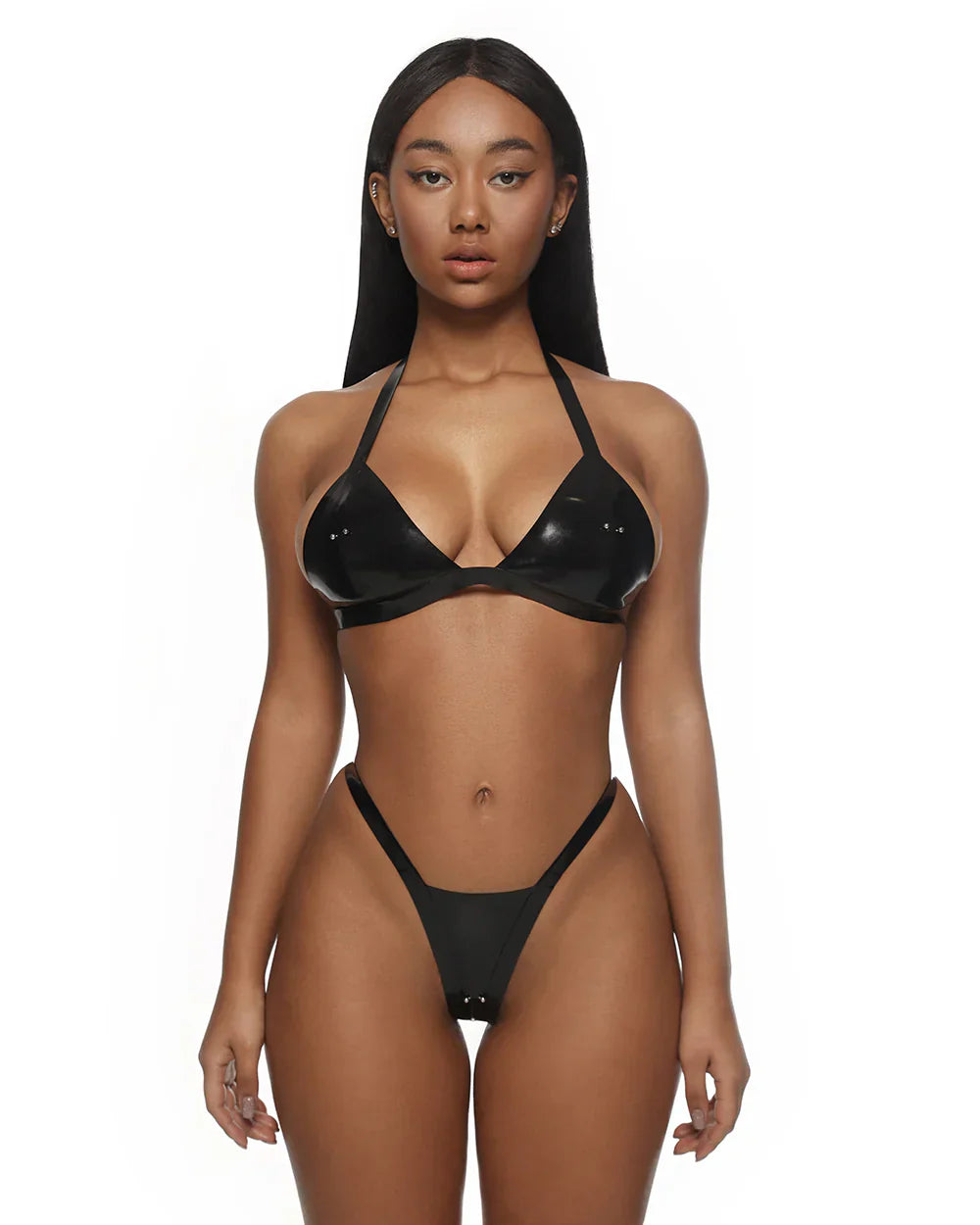 Woman wearing a black latex bikini on a white background