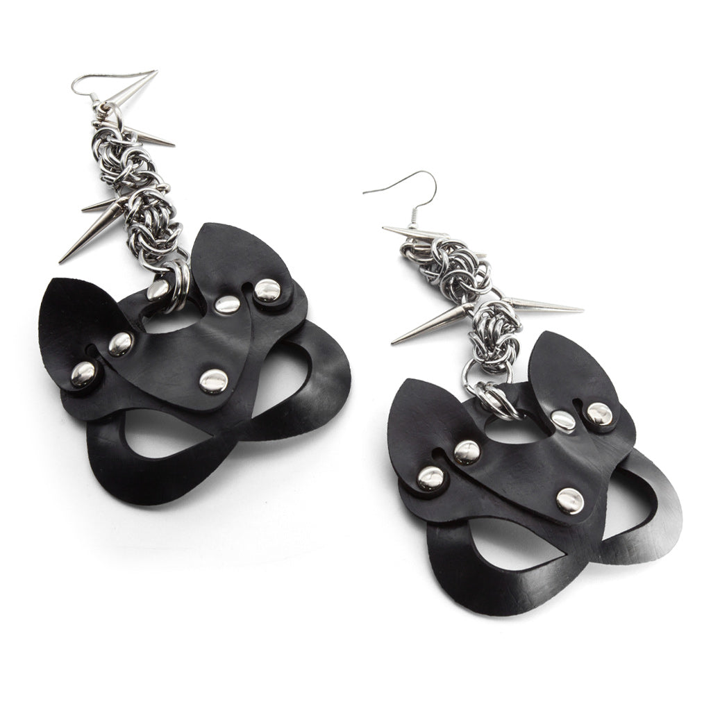 Black cat-shaped earrings with silver accents on a white background
