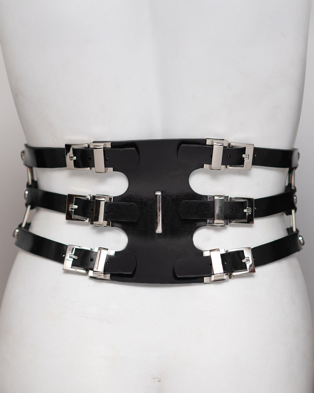 The back of the secura waist cincher is shown on a mannequin in front of a gray background.