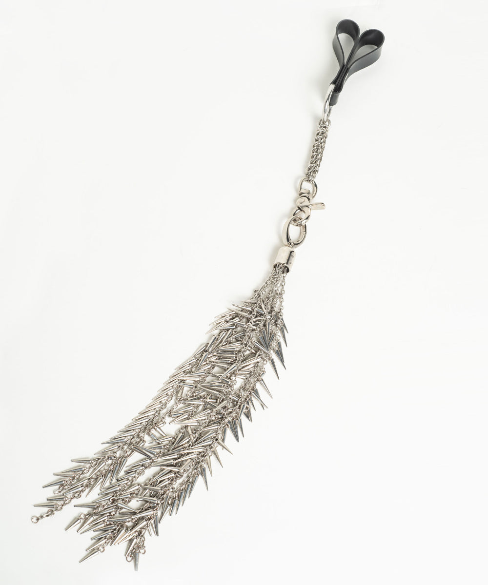 Silver feather-shaped flogger on a white background