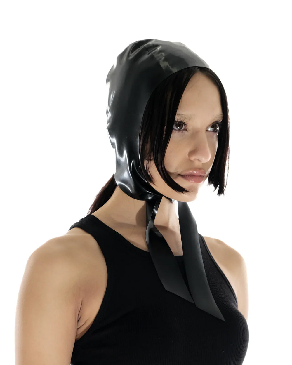 A brunette model is shown wearing the black latex bonnet against a white background.
