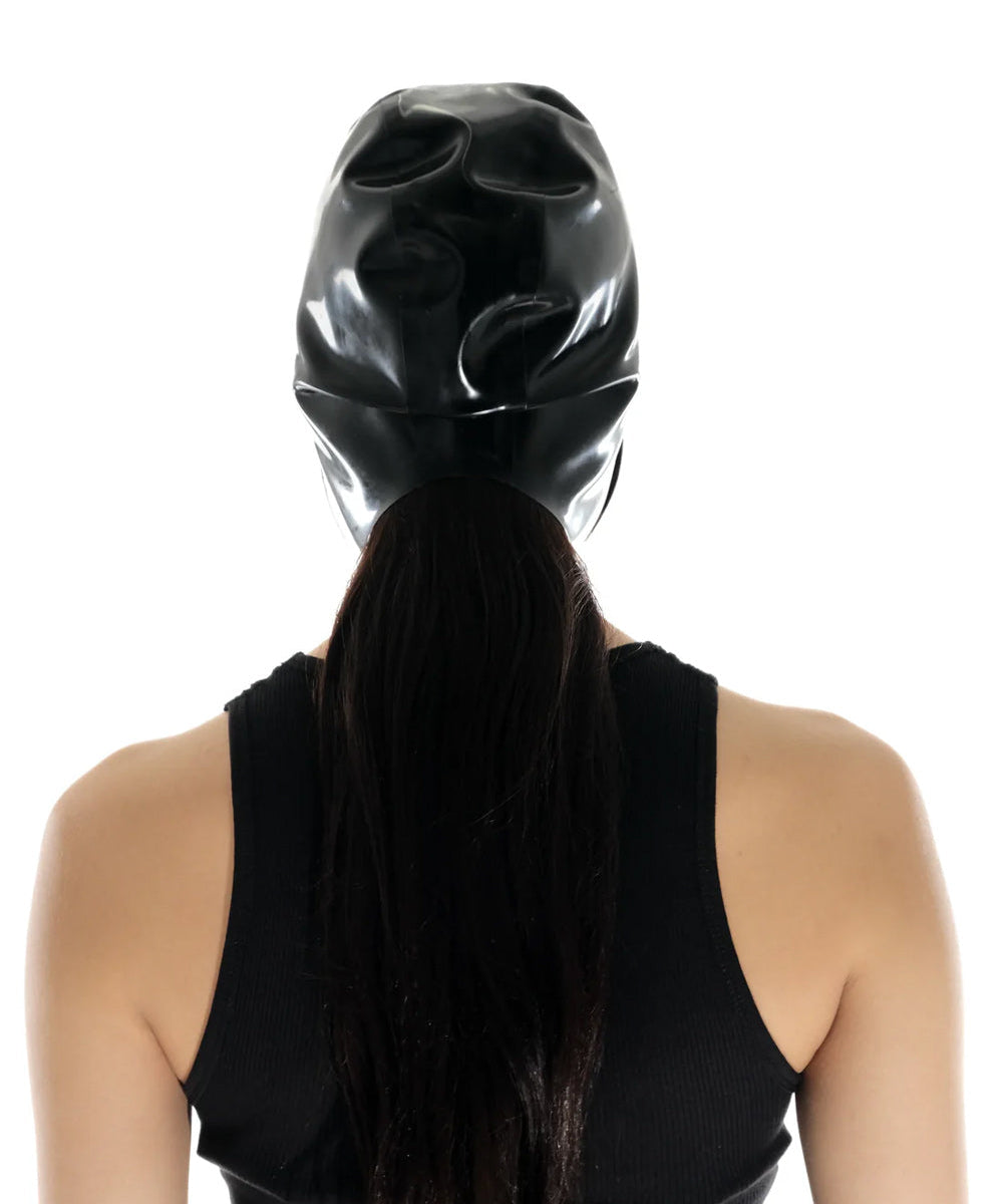 A brunette model is shown from the back wearing the black latex bonnet against a white background.