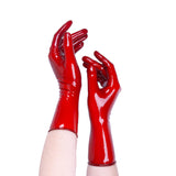 Red glossy gloves worn on a white background