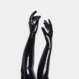 Black glossy opera length gloves on a white background