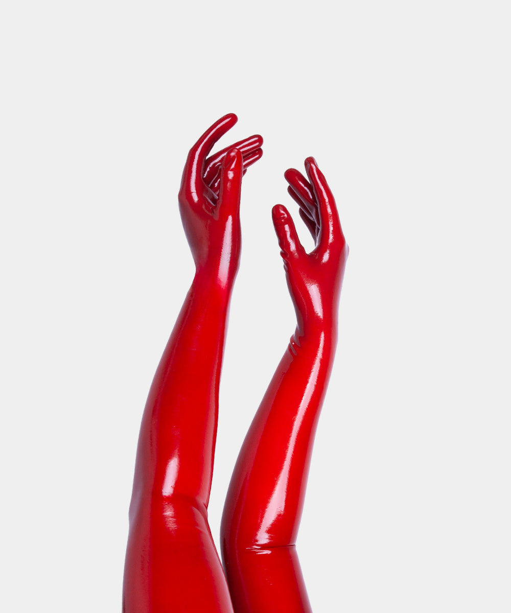 Red glossy opera length gloves on a white background