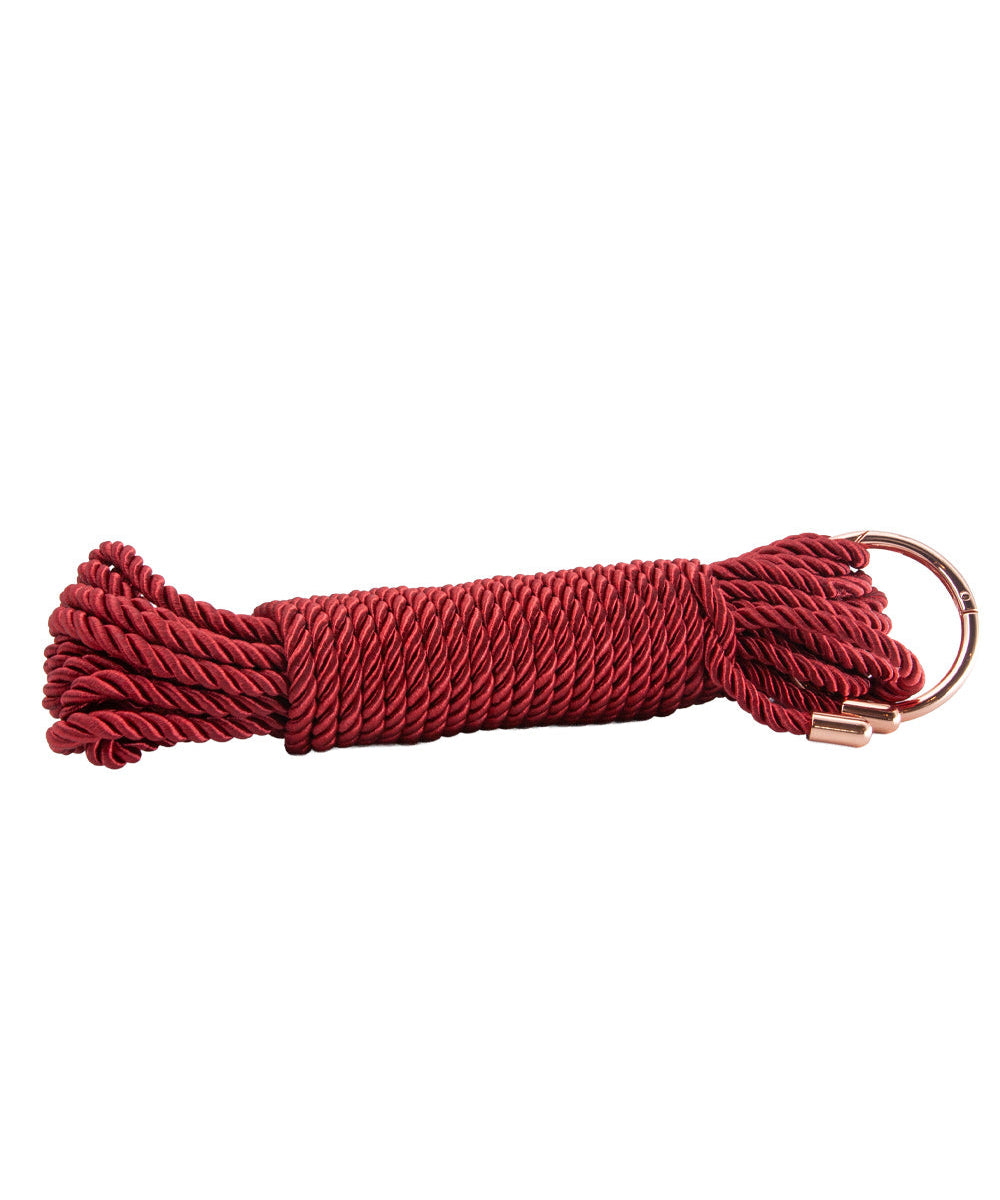 Red rope with a metal clip on a white background