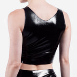 The back of a person wearing a black latex crop top on a white background