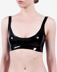 A model is shown wearing a glossy latex basic halter bra, standing in front of a white background.