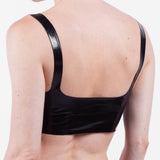 The back of a model is shown wearing a glossy latex basic halter bra, standing in front of a white background.