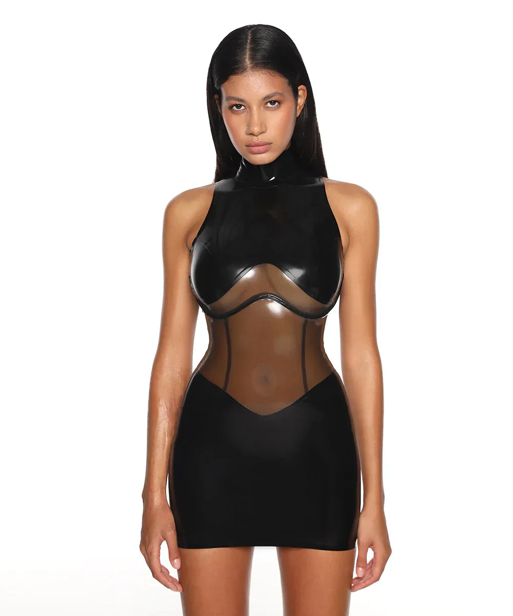 A close-up of a model is shown wearing the black casey latex dress standing in front of a white background.