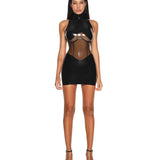 A model is shown wearing the black casey latex dress standing in front of a white background.