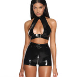 A model is shown wearing the black swish latex shorts in front of a white background. 