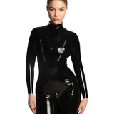 A close-up of a model wearing the black cortex catsuit with zippers standing against a white background.