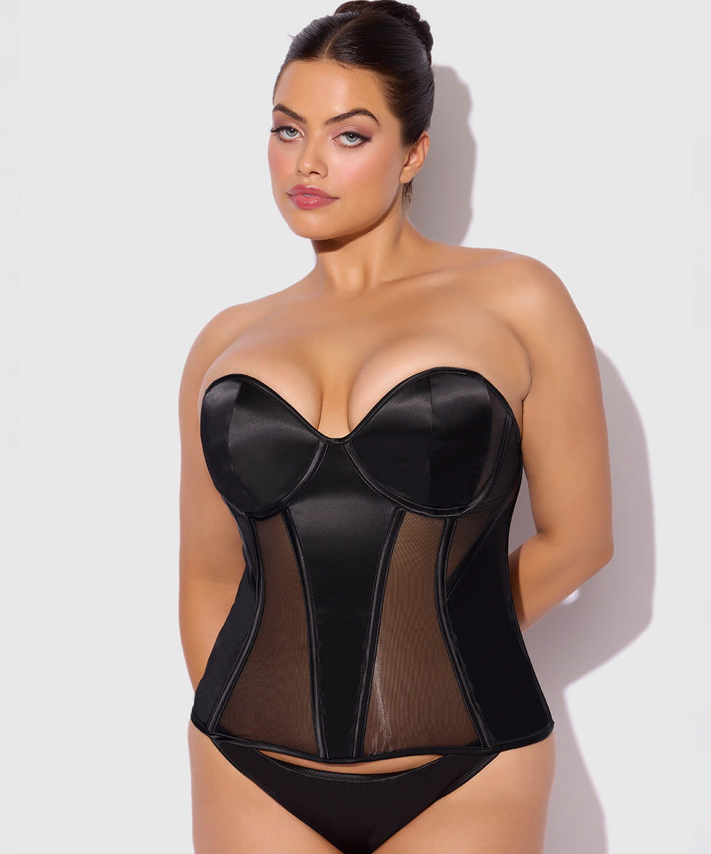 Woman wearing a black sheer corset against a white background