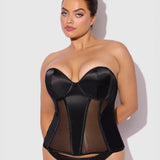 Woman wearing a black sheer corset against a white background