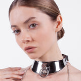 a close-up-of a model is shown wearing the Theodora collar standing in front of a white background. 
