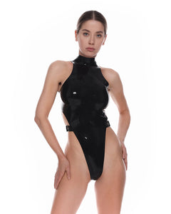 A close-up of a model is shown wearing the black stella010 latex bodysuit in front of a white background.