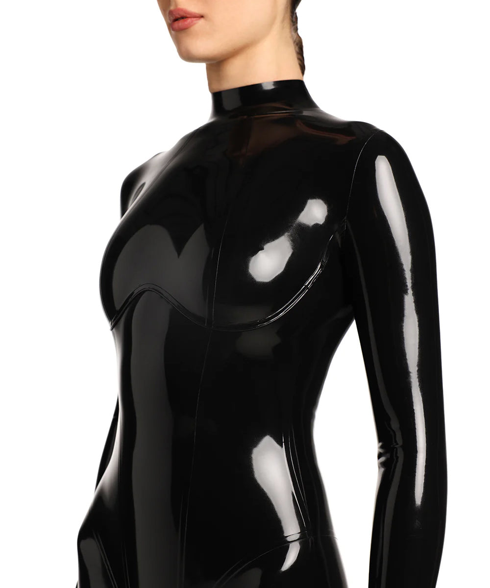 A close-up of the a models upper body is shown in the black kinetic latex catsuit. She is standing in front of a white background. 