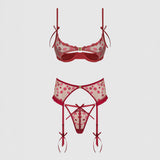 Red and pink patterned lingerie set on a light gray background