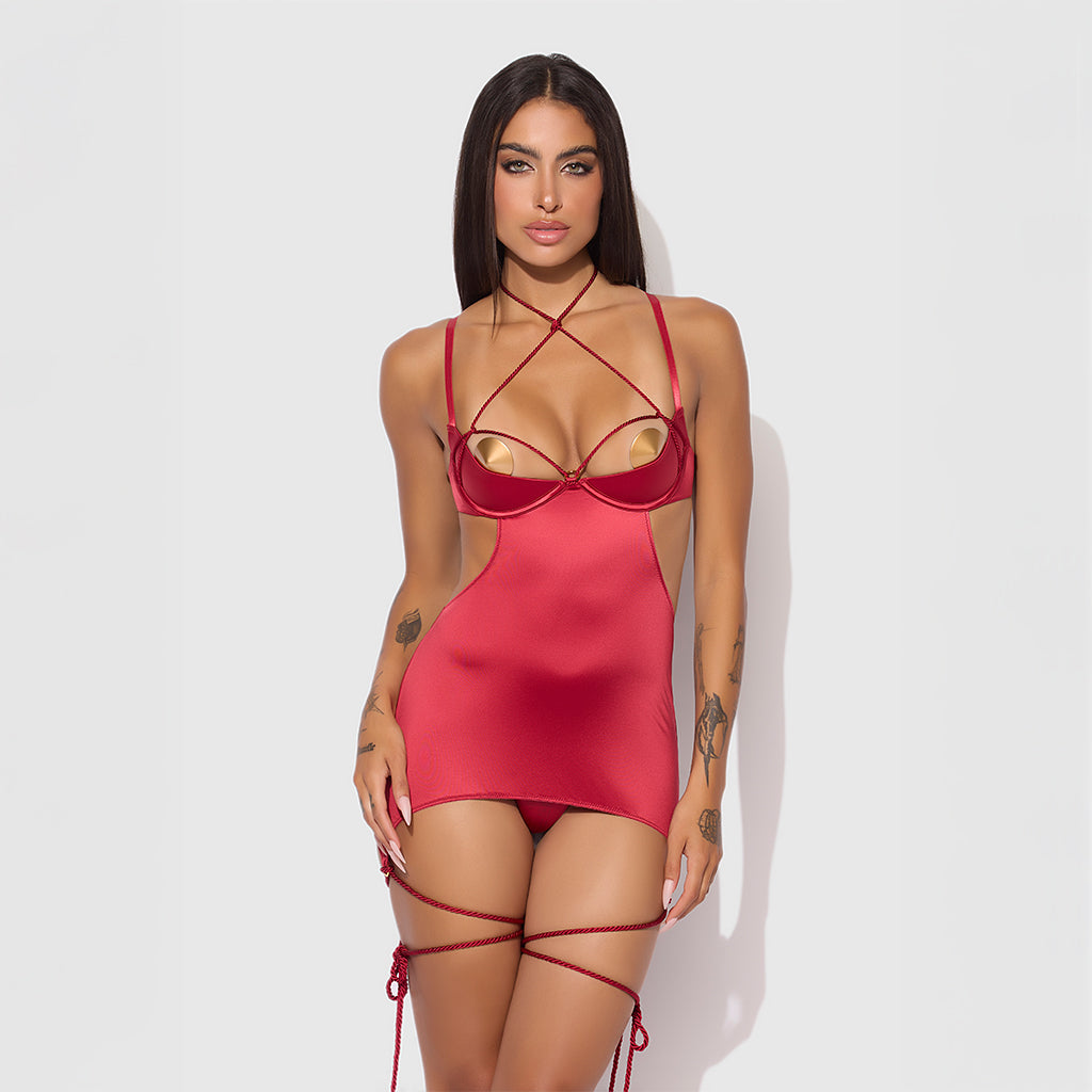 Woman wearing a red strappy outfit on a white background