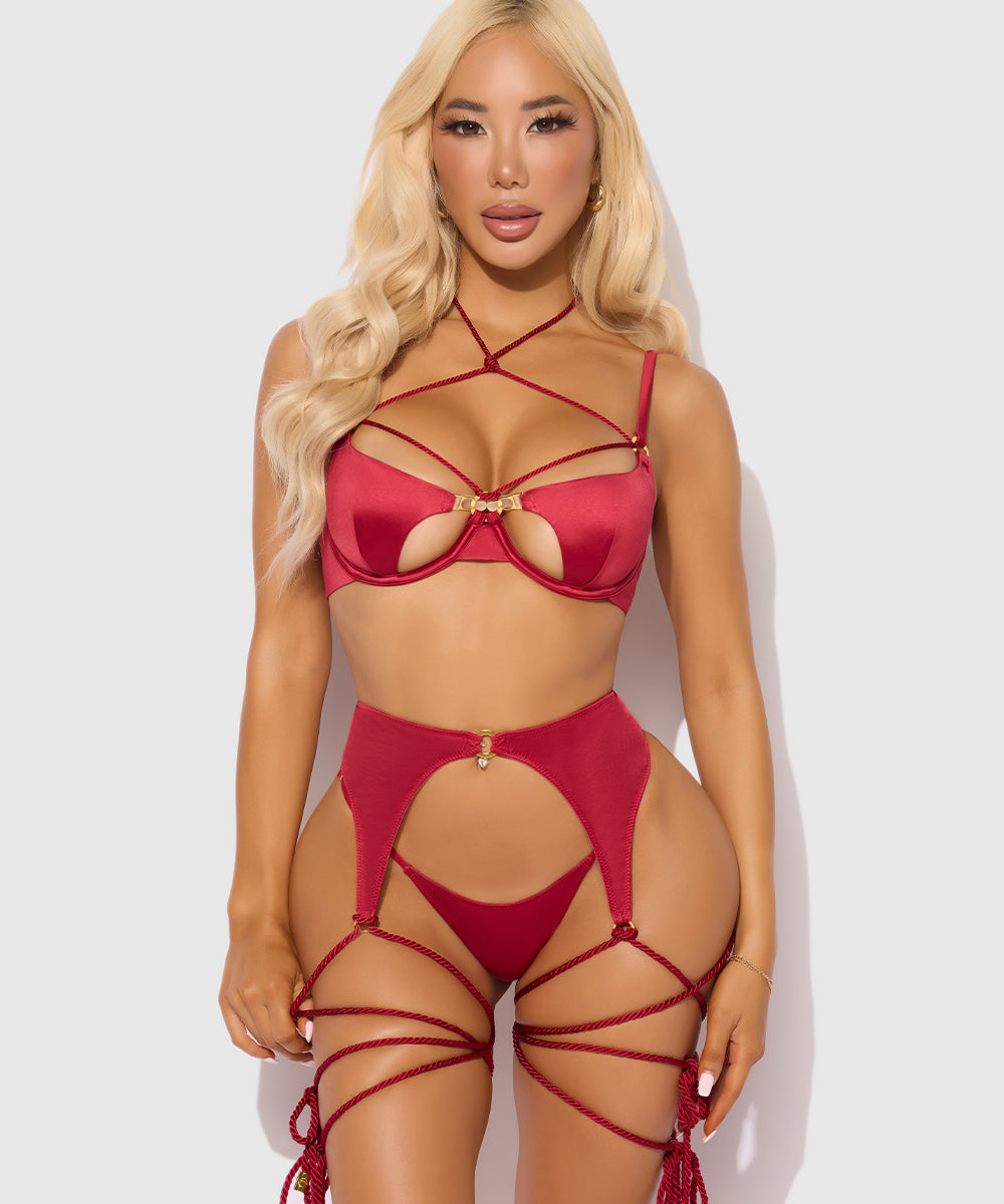 Woman wearing a red strappy bikini against a white background