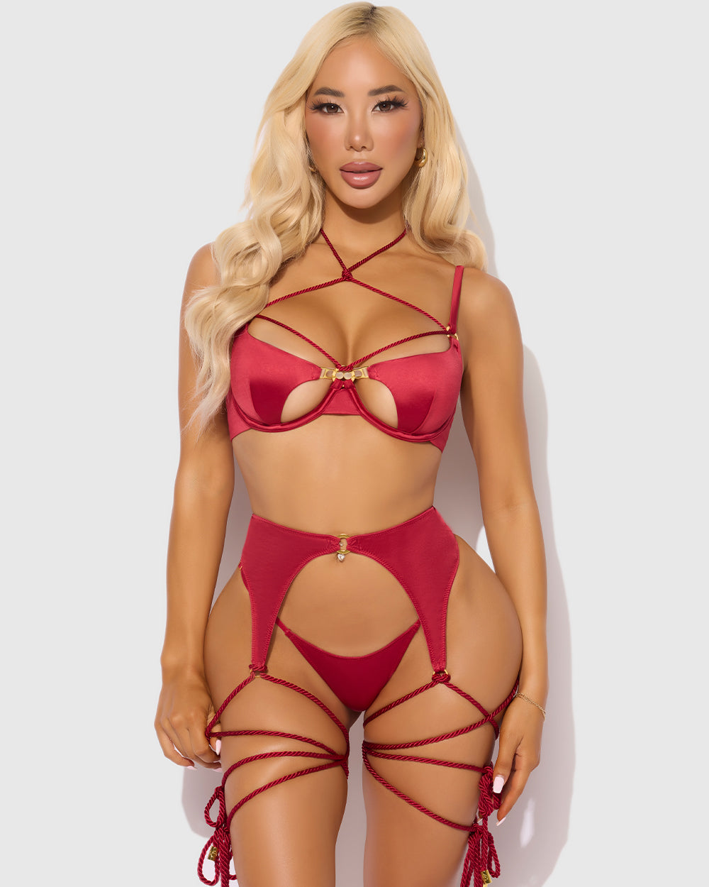 Woman wearing a red strappy bikini against a white background