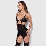 Woman wearing a black fishnet bodysuit against a white background