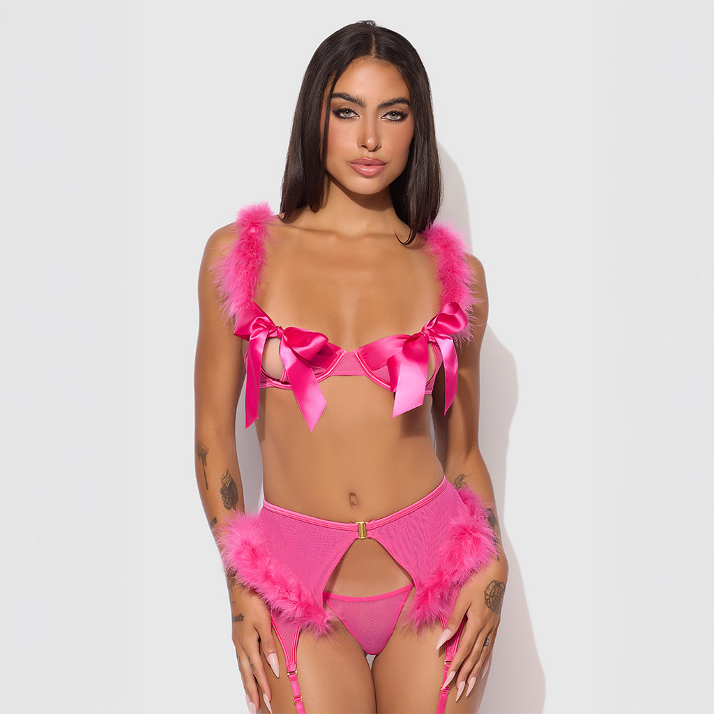 Model wearing a pink bikini with feather details against a white background