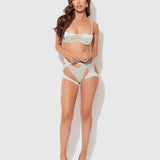 Woman wearing a light green lingerie set on a white background