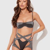 Woman wearing a gray bikini against a white background