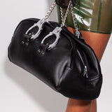 A model is shown holding the leather doctor bag with handcuff handles