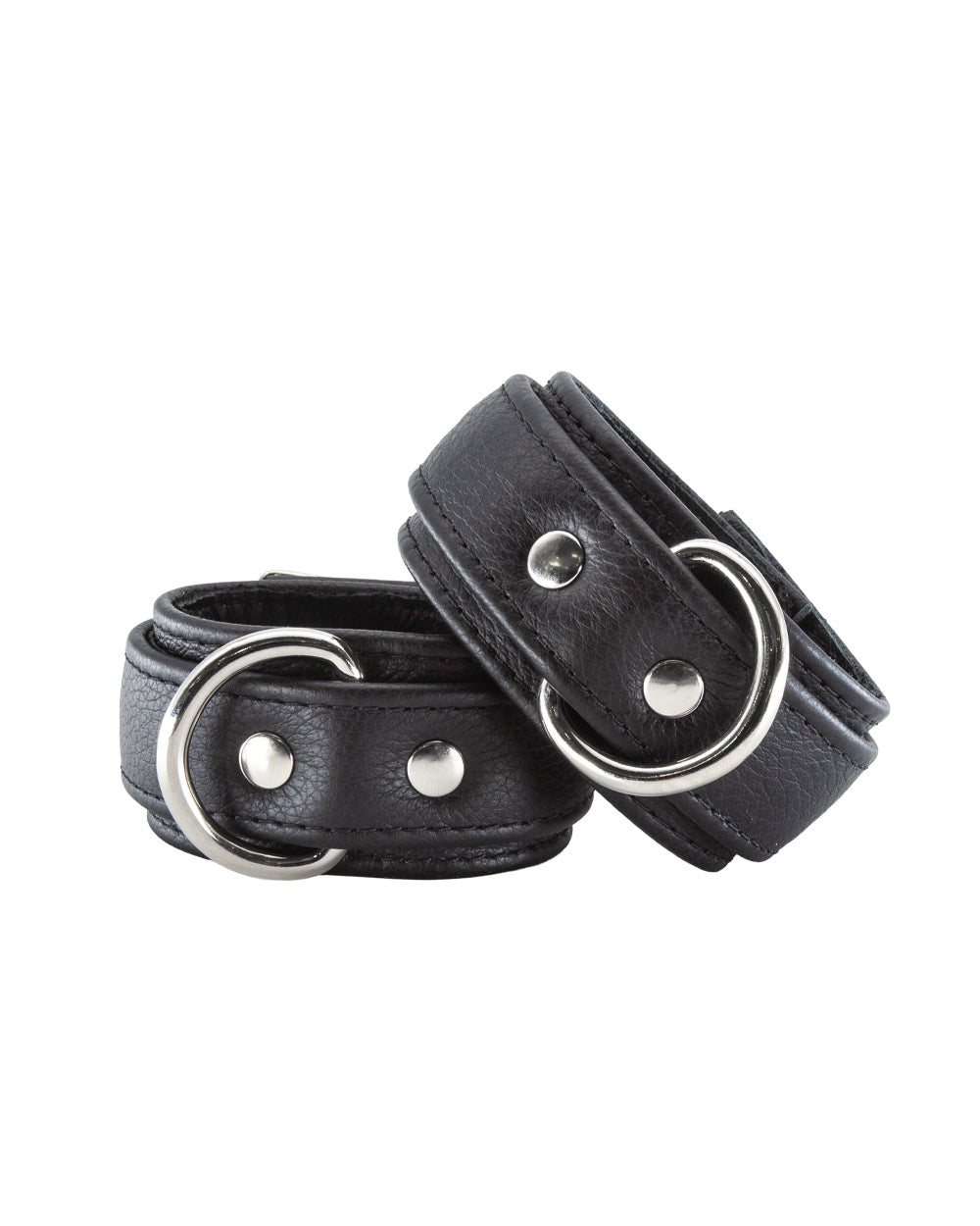 A pair of Premium Garment Leather Wrist Cuffs in black are shown against a blank background. The cuffs are made of black leather with silver hardware. They each have a D-ring and a lockable metal buckle.