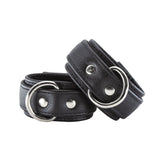 The black premium garment leather ankle cuffs are show against a white background