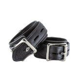 The back of the black premium garment leather ankle cuffs are show against a white background