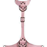 Pink leather harness with metal rings on a white background