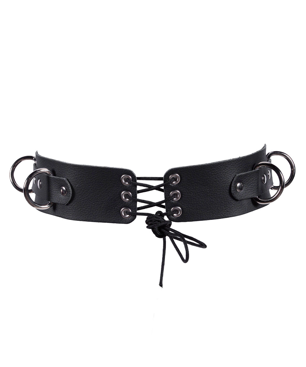 The back of the black leather harness with metal buckles on a white background