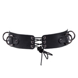 The back of the black leather harness with metal buckles on a white background