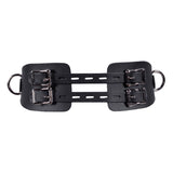Black leather harness with metal buckles on a white background
