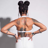 A back close-up of a model wearing the Stormy Leather Showgirl bra against a light gray background.