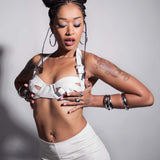 A lifestyle shot of a model wearing the Stormy Leather Showgirl bra against a light gray background.
