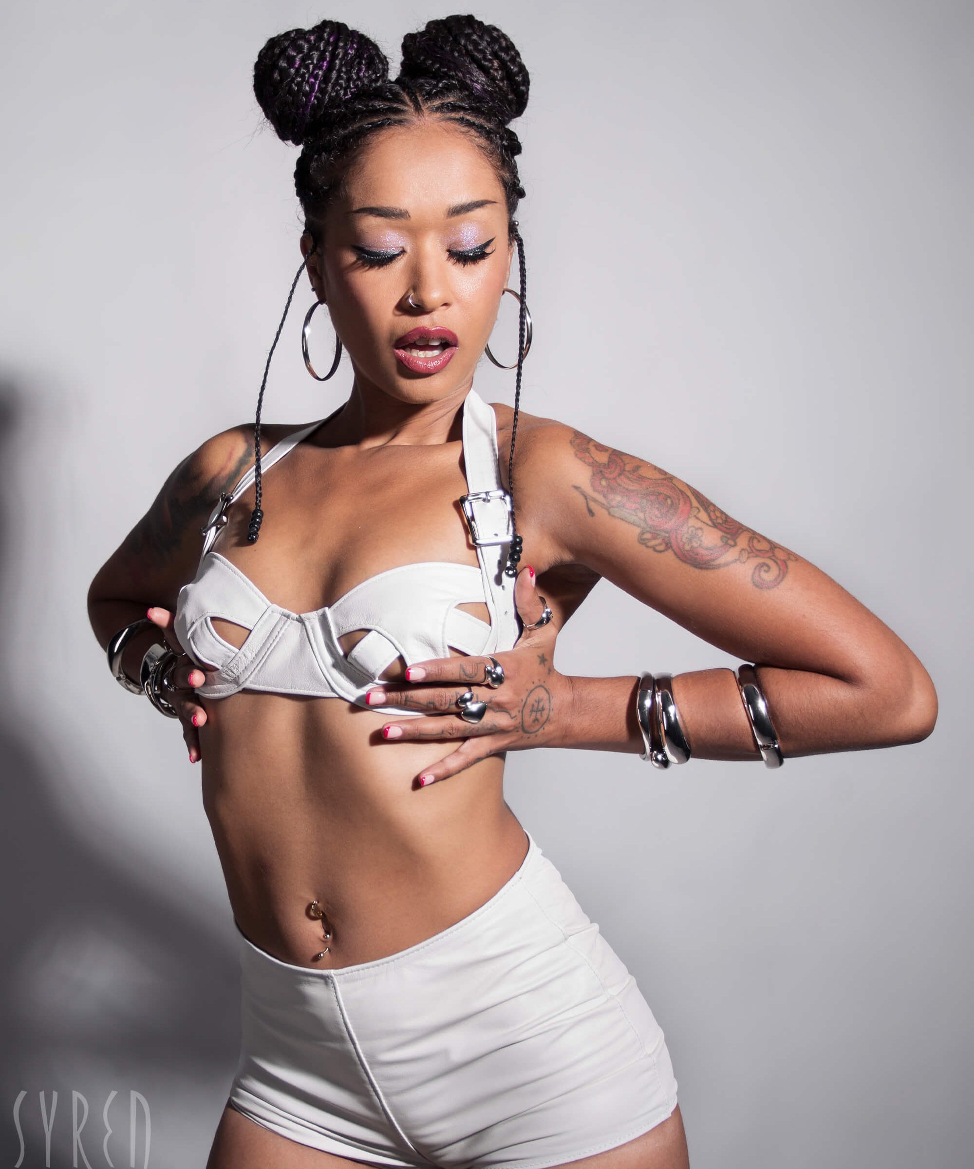 A lifestyle shot of a model wearing the Stormy Leather Showgirl bra against a light gray background.